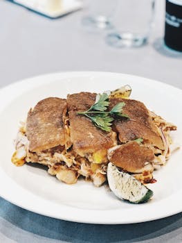 Close-up of a savory meat quesadilla served with a lime wedge, perfect for a delicious meal.