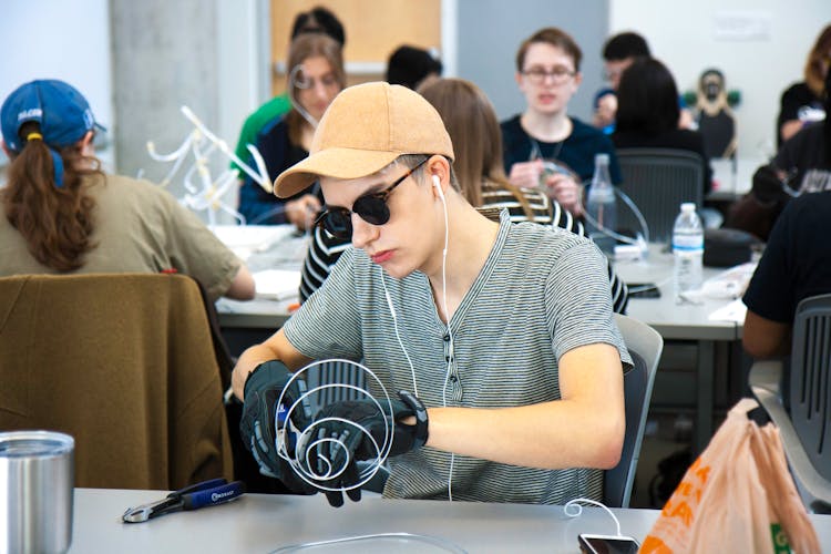 A Male Student Doing A Wire Sculpture