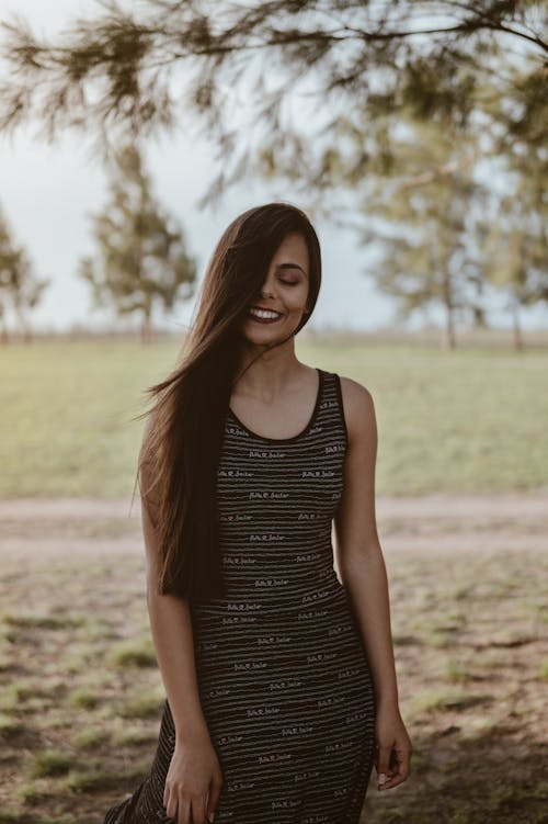 Beautiful Woman Standing at The Park With Her Eyes Closed