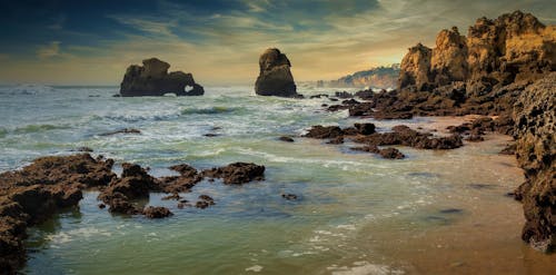 Free Scenic View of Rock Formations on the Beach Stock Photo