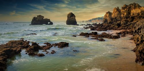 Free Breathtaking view of rocky coastline at sunrise, perfect for travel imagery. Stock Photo