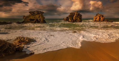 Free Captivating sunset scene with rugged rock formations along a dramatic seashore. Stock Photo