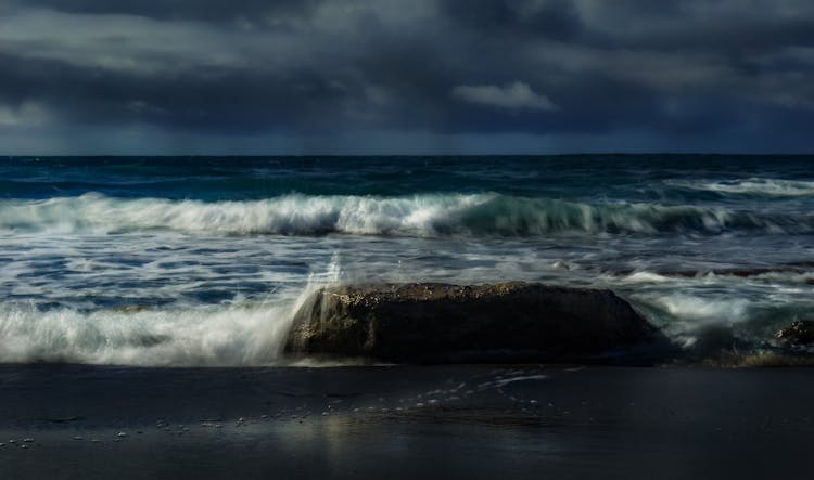 Photograph Of Ocean Waves Crashing On A Rock