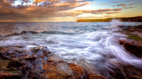 Waves Crashing on the Shore during Sunset