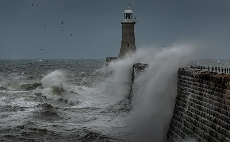 Ocean Waves Crashing Near The Lighthouse