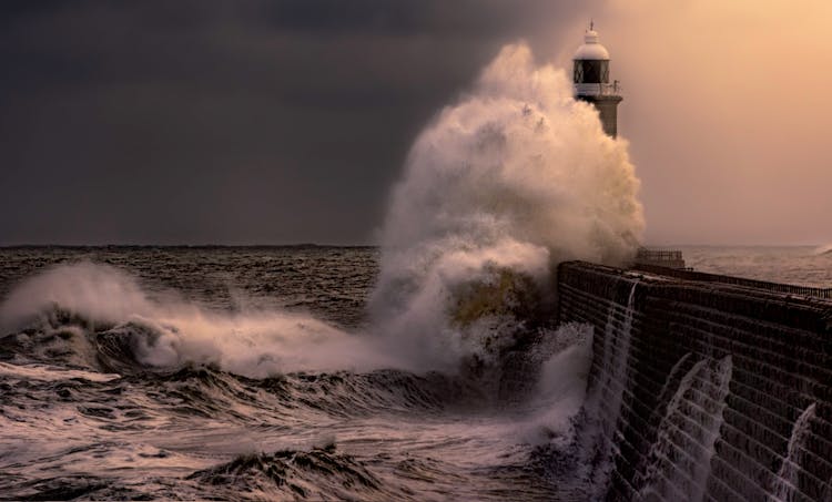 Ocean Waves Crashing Near The Lighthouse