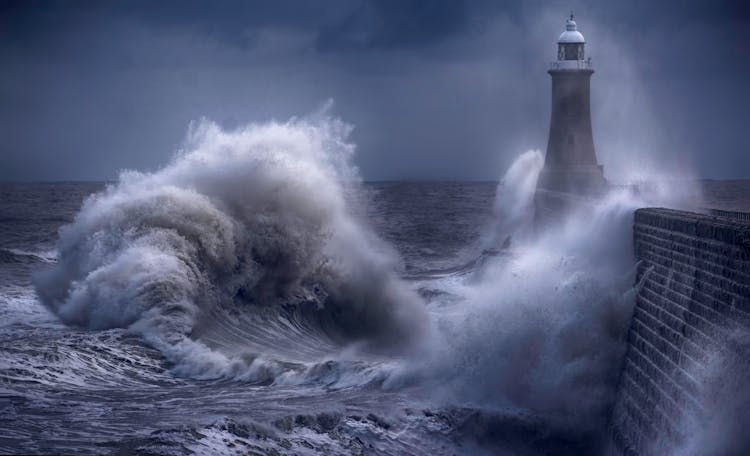 Ocean Waves Crashing Near The Lighthouse