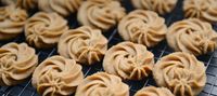 Piped butter cookies cooling on a rack — photo by Cats Coming on Pexels
