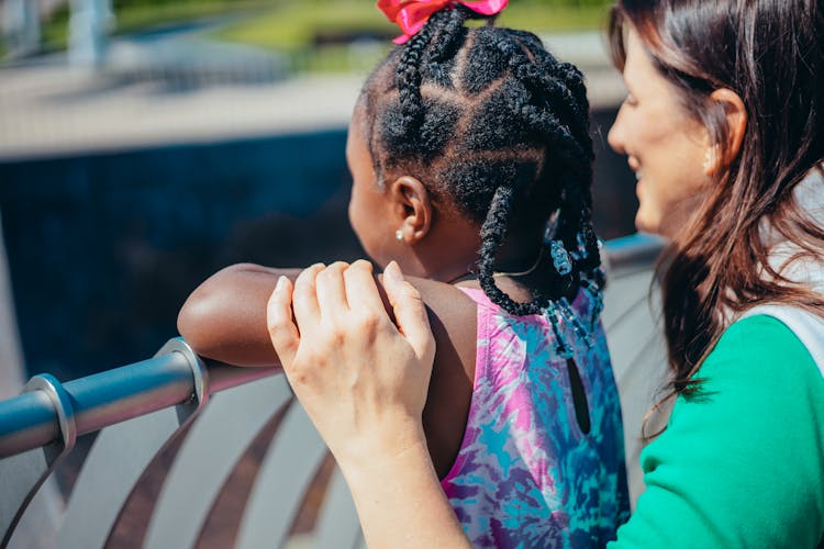 A Woman Holding A Young Girl