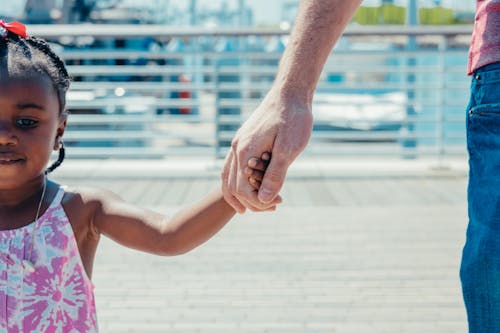 A Girl Holding a Person's Hand 