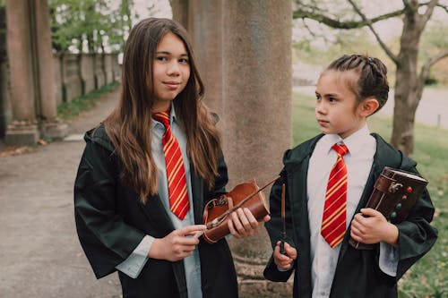 Girls in Black Robes Holding Wands