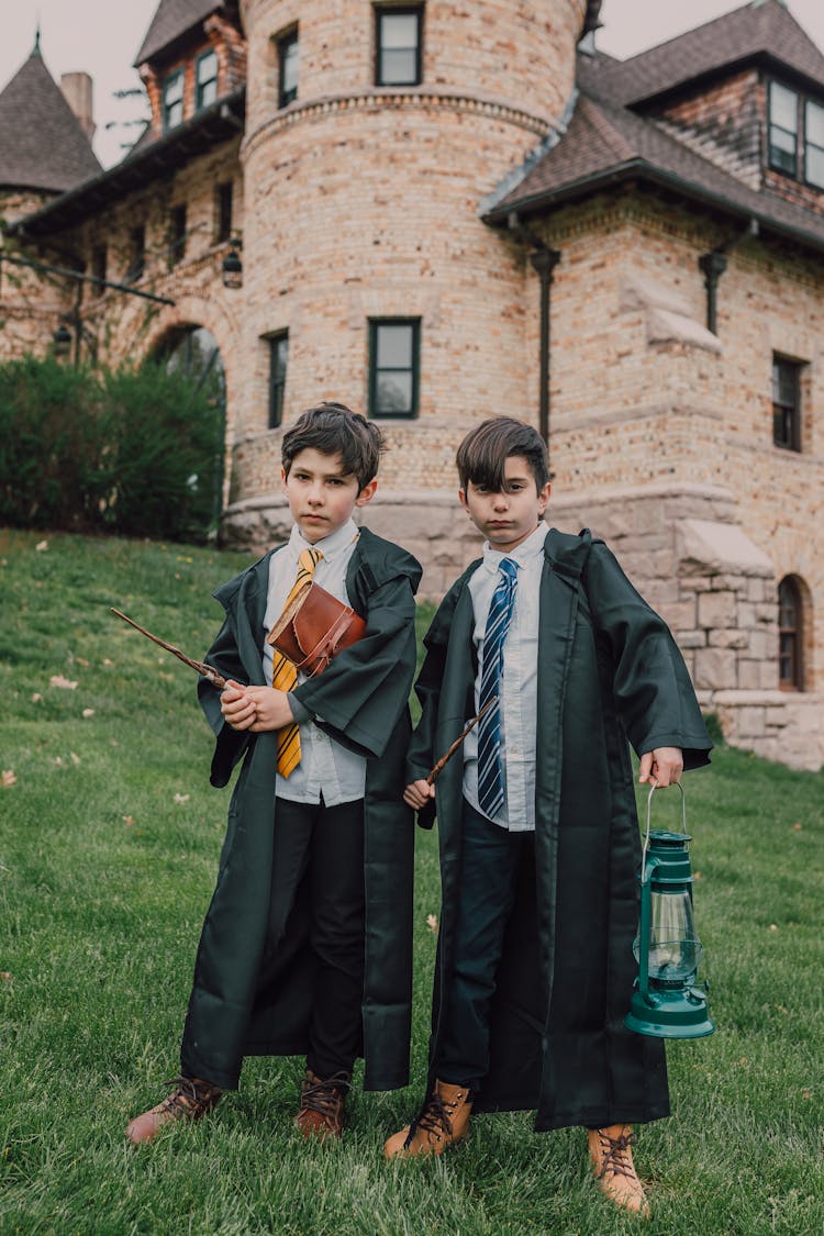 Boys In Black Robes Holding Wands