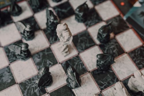 Free Artistic top-down photo of a decorative chessboard with unique chess pieces, emphasizing strategy and focus. Stock Photo