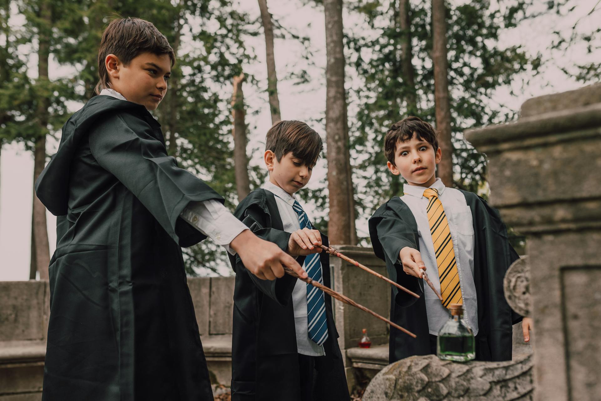 Boys in Black Robes Holding Wands