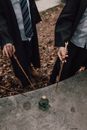 Hands Pointing the Magic Wands at the Glass Bottle