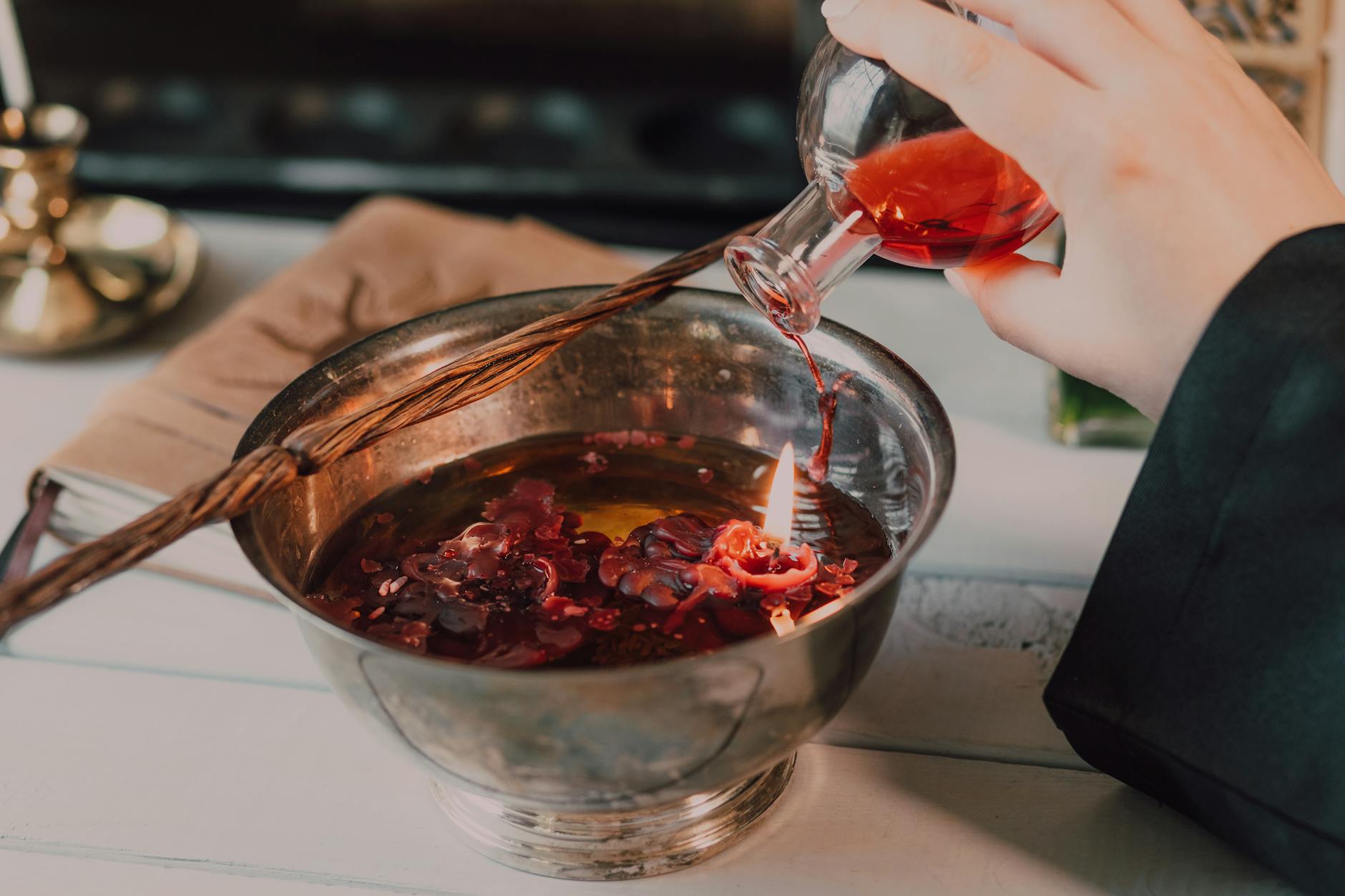 Hand Pouring Red Liquid in Stainless Steel Bowl 