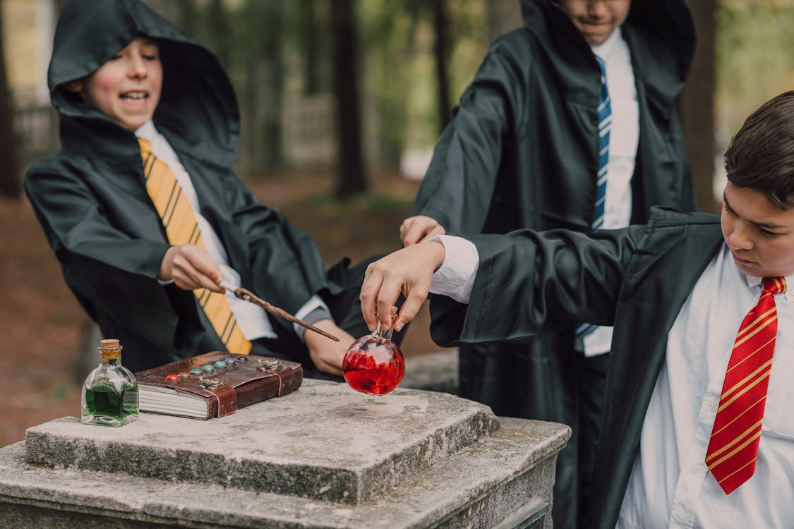 Boys in Black Robes Playing as a Wizard