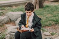 Man in Black Suit Jacket Reading Book