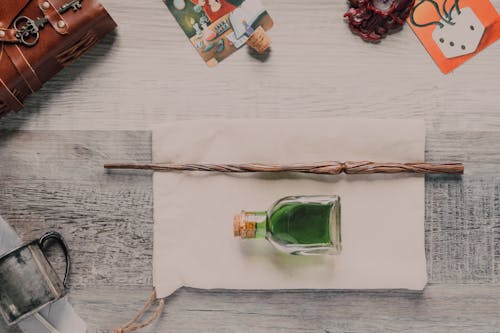 Wooden Magic Wand and Jar on Top of White Pouch