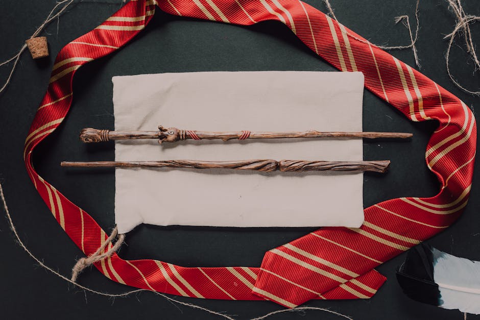 Wands and striped necktie on a dark backdrop, evoking a magical theme.