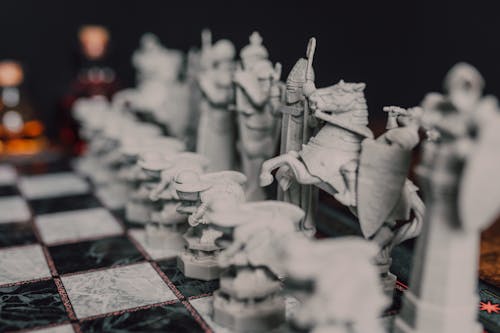 Gray Chess Pieces on Black and White Chessboard