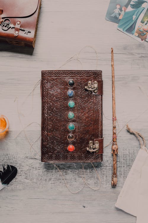 Seven Chakra Stone Book Beside Magic Wand  