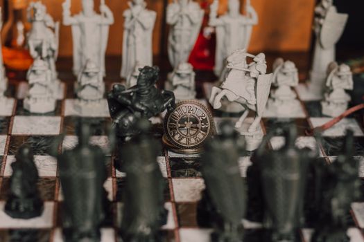 Detailed close-up of a medieval-themed chess set with ornate pieces on a chessboard.