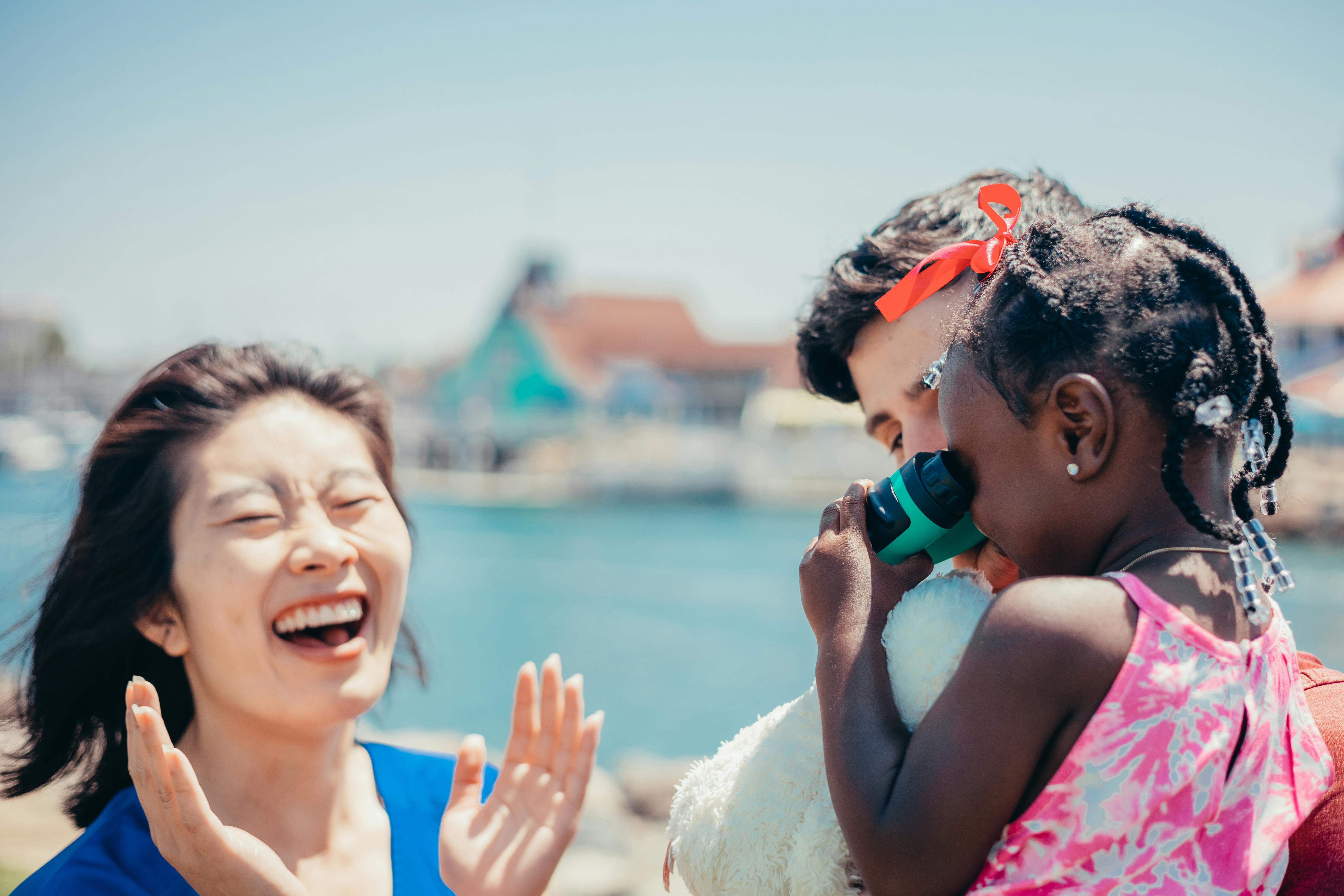 A happy multicultural family bonding and playing together outdoors on a sunny day, showcasing love and togetherness.