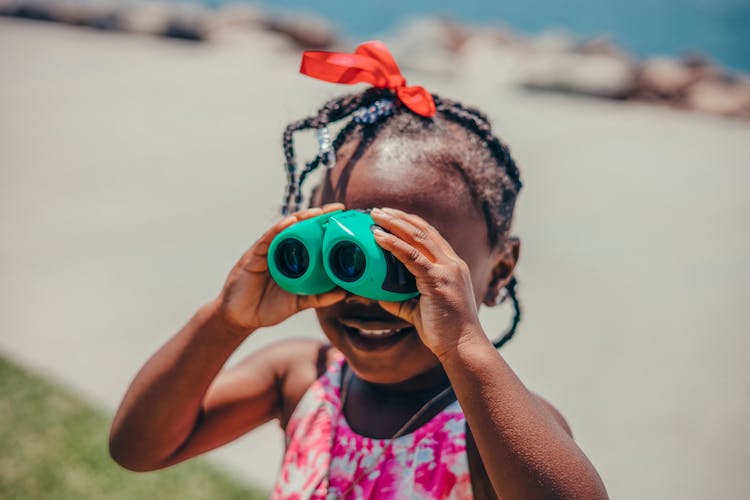 Close Up Shot Of A Girl Using Binocular