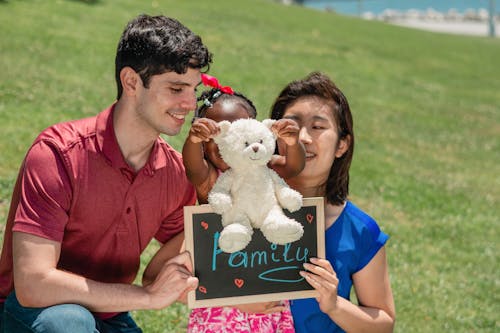 A Happy Family on a Grassy Field