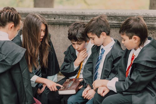 Free Group of Kids Looking at an Old Book Stock Photo
