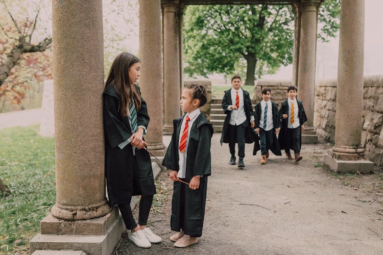 Children  In Black Robes Holding Wands