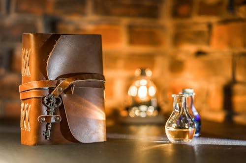 Close-Up Shot of a Spell Book beside a Potion