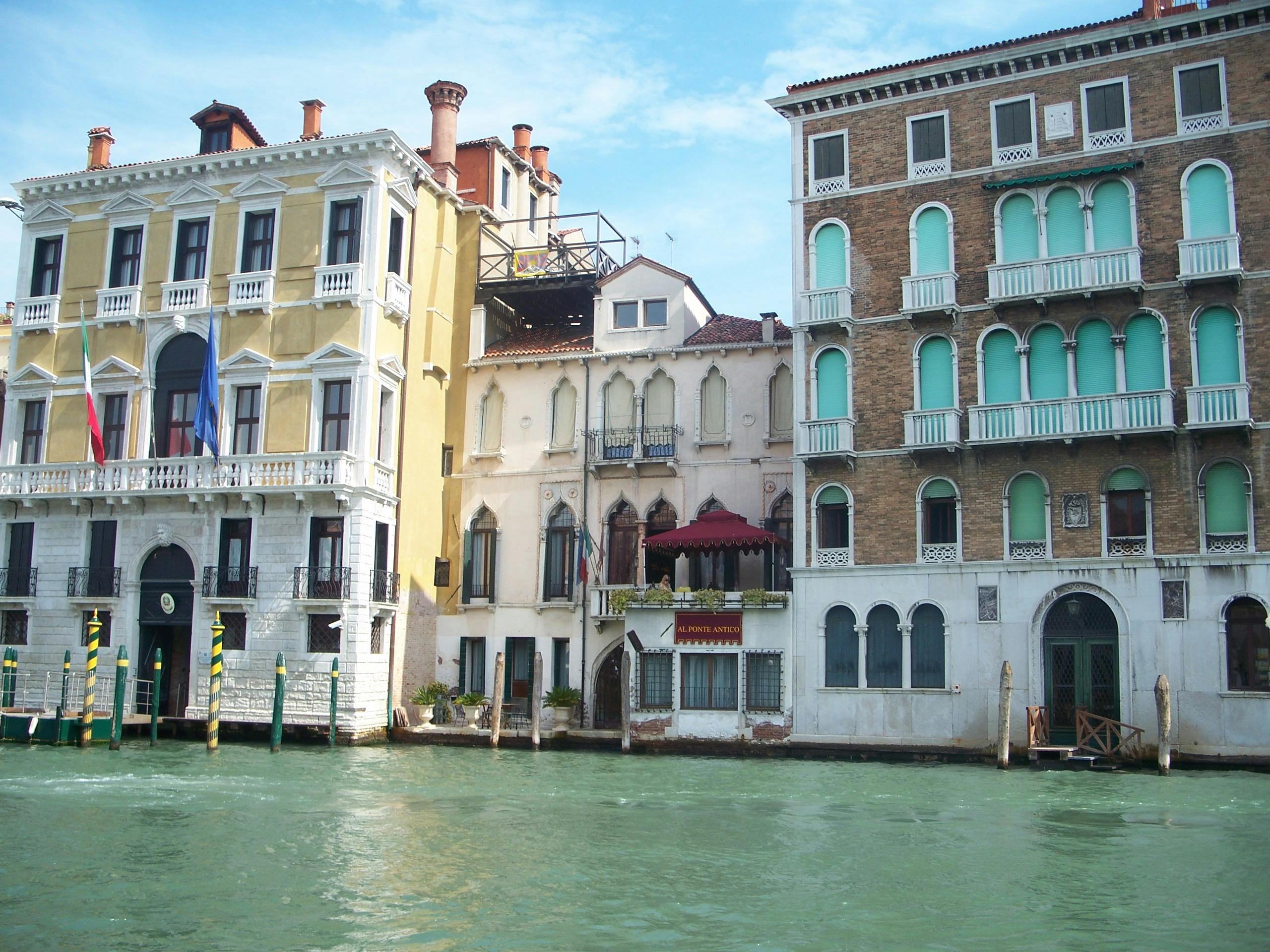 Person reading news on a phone while taking notes at a desk