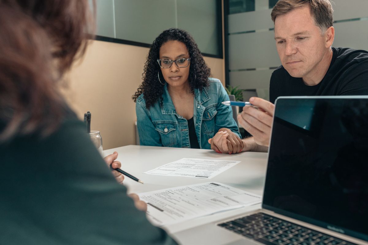 Advisor discussing financial information with a couple