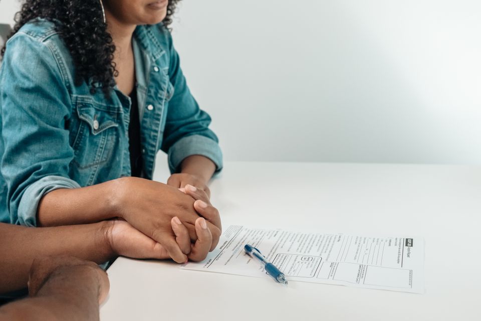 Prospective parents review adoption paperwork together.