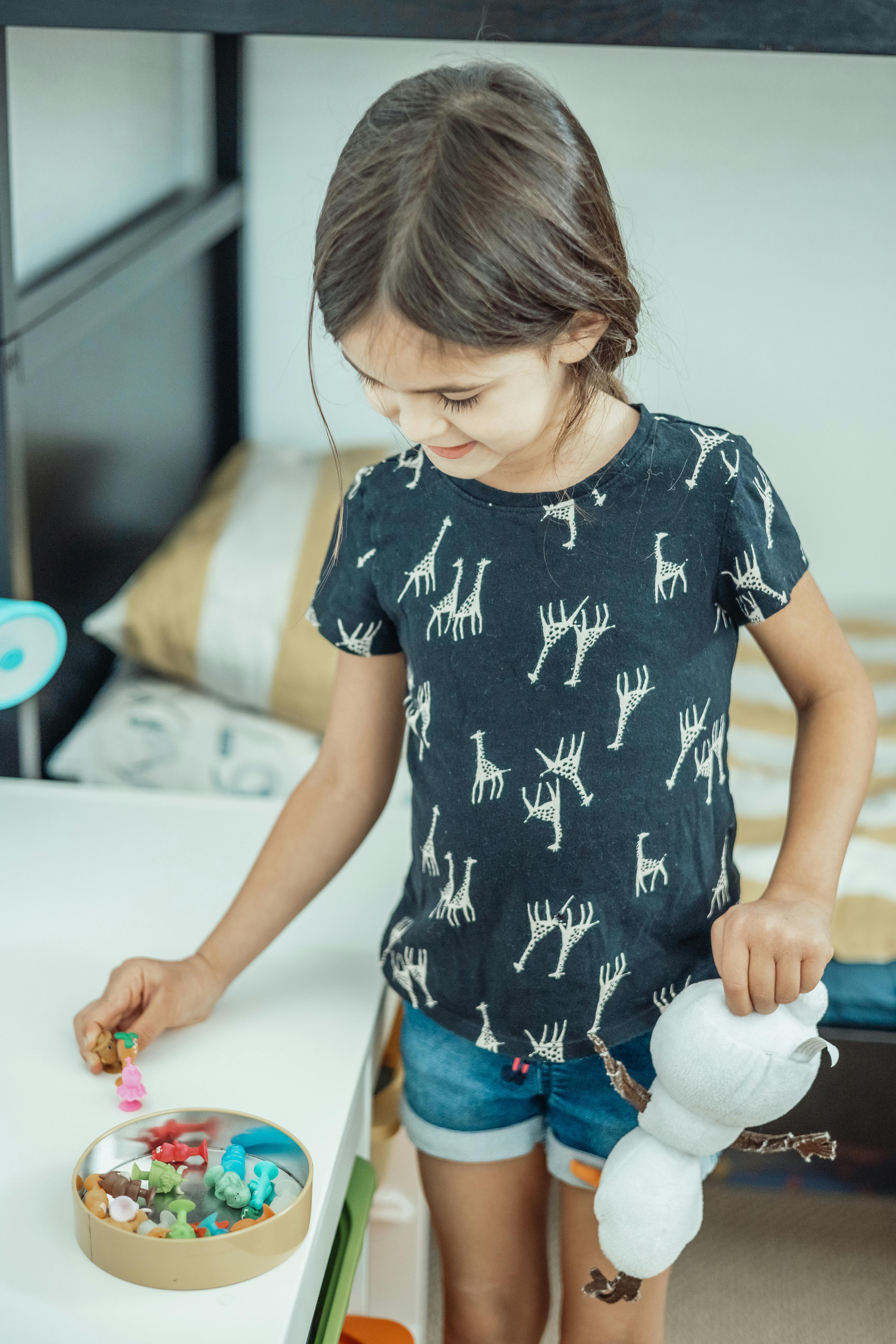 a cute girl playing with toys