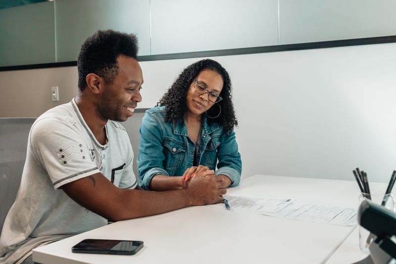 Cape Town couple reviewing legacy and estate planning documents with a financial adviser
