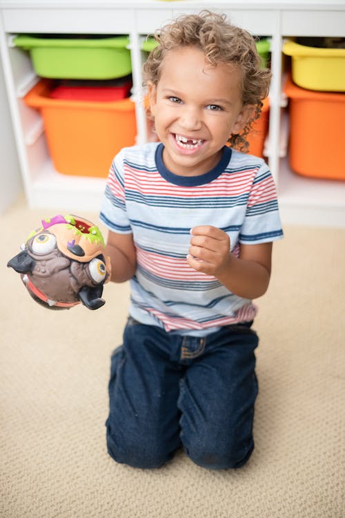 Photo of a Boy Playing with a Toy