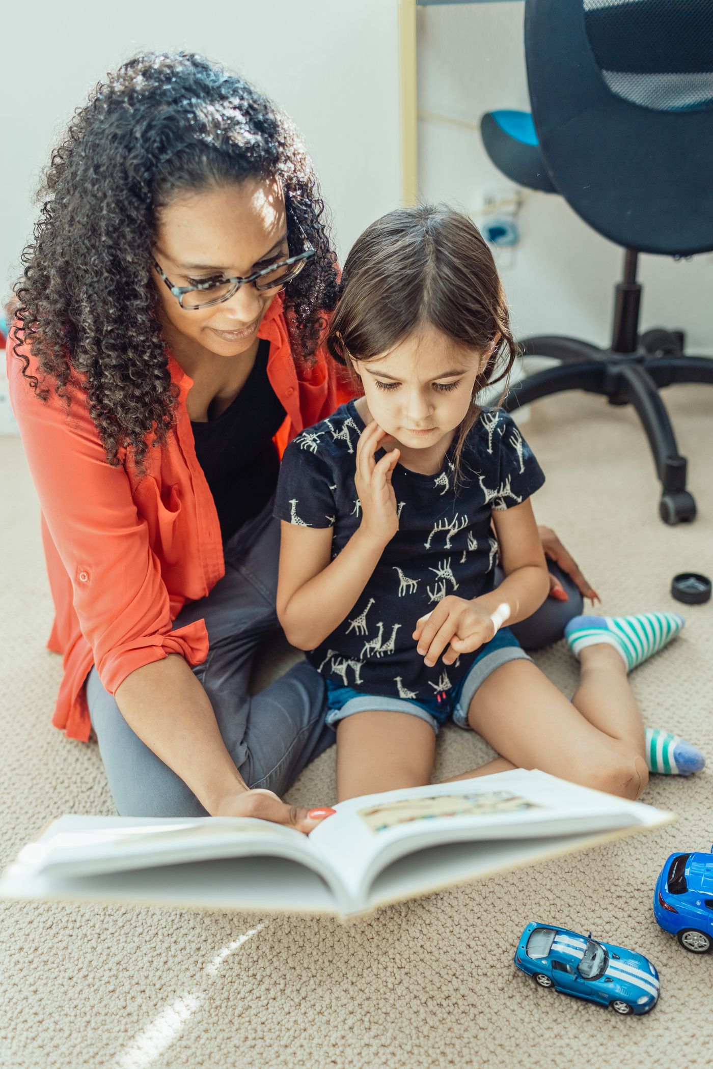 Mother and child reading together at home