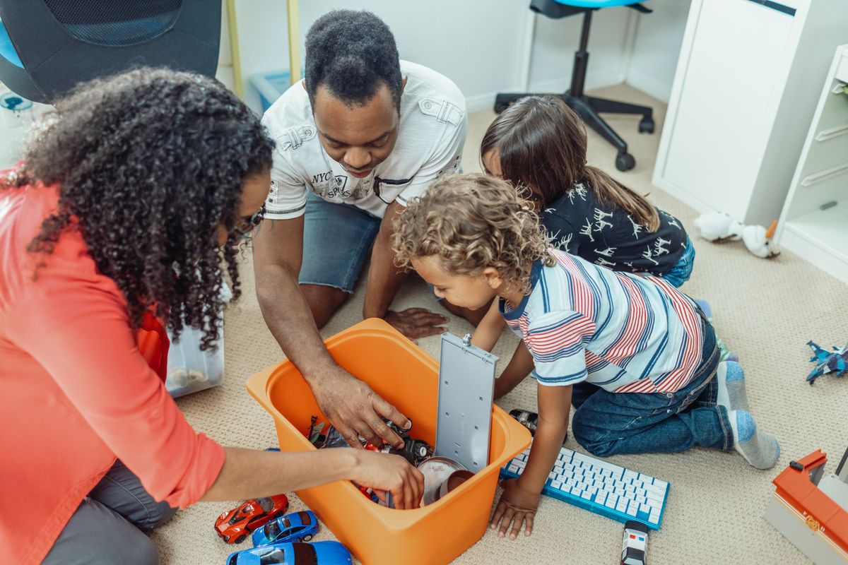 A family playing together with toys during a shared learning activity