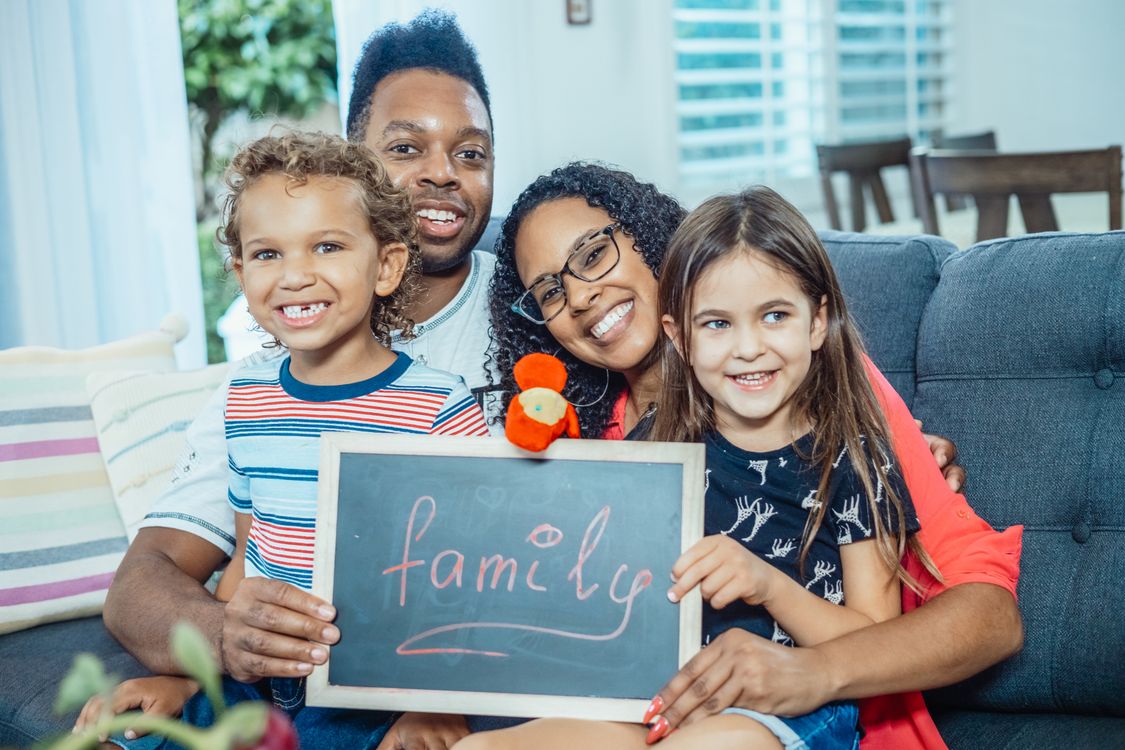 Diverse family with children smiling — welcoming all patients at Family Dental Center of Connecticut in Wethersfield CT