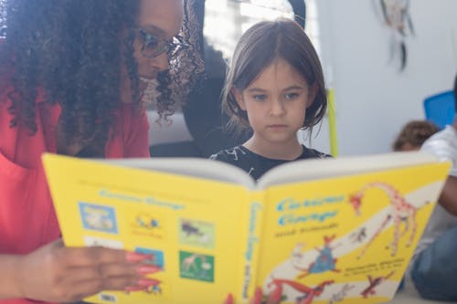 A Teacher Reading Story to a Girl