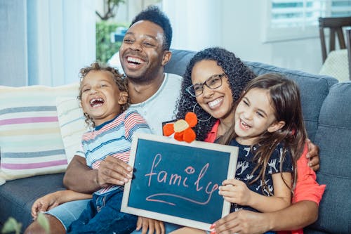 A Happy Family Sitting on a Couch