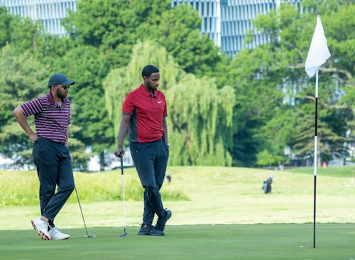 Free Men Playing a Game of Golf Stock Photo