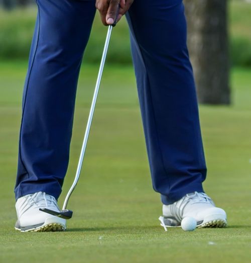 Free Close-up of golfer in Washington DC preparing for a putt on a sunny day. Stock Photo