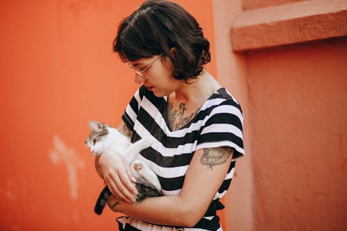 Woman with Tattoo Holding a Cat