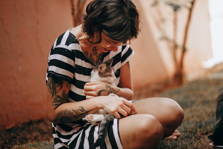 Tattooed Woman Hugging A Cat 