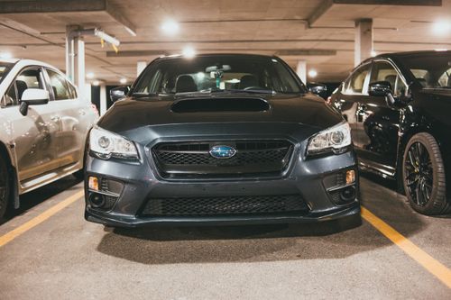 Free Front view of a Suburu parked in an indoor parking garage, well-lit and spacious. Stock Photo