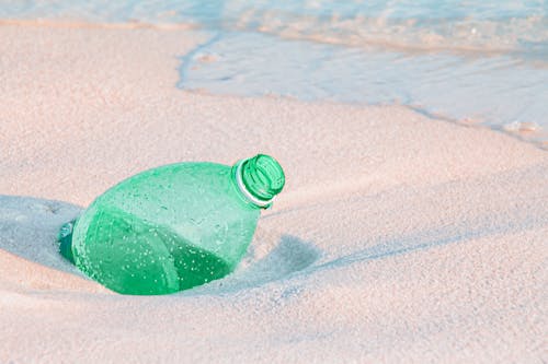 Plastic Bottle in Sand on Beach